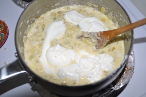 Stirring the sour cream mixture into the asiago artichoke dip